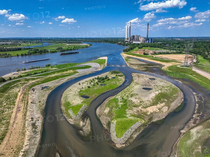 Dinslaken, Voerde, North Rhine-Westphalia, Germany, Renaturalisation of the Emscher. New Emscher estuary into the Rhine. Flood protection through land expansion. The decommissioned STEAG coal-fired power station in Voerde in the background. The mouth of the Emscher into the Rhine was moved from Dinslaken to Voerde, almost 500 metres to the north. Fish can now swim barrier-free up the new Emscher from the Rhine through a newly created floodplain area. Following the construction of a parallel sewer, the Emscher has been completely free of sewage since January 2022. The river was previously an open, above-ground combined sewer with rainwater and wastewater, Europe