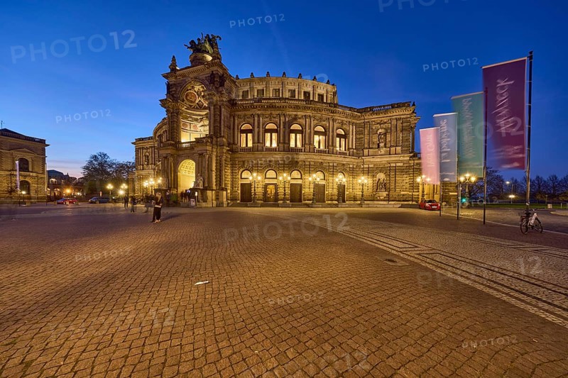 Semperoper, architectural style neo-renaissance, architect Gottfried Semper, flags with programme of the Dresden State Opera, motion blur, evening blue hour, Theaterplatz, Dresden, state capital, independent city, Saxony, Germany, Europe