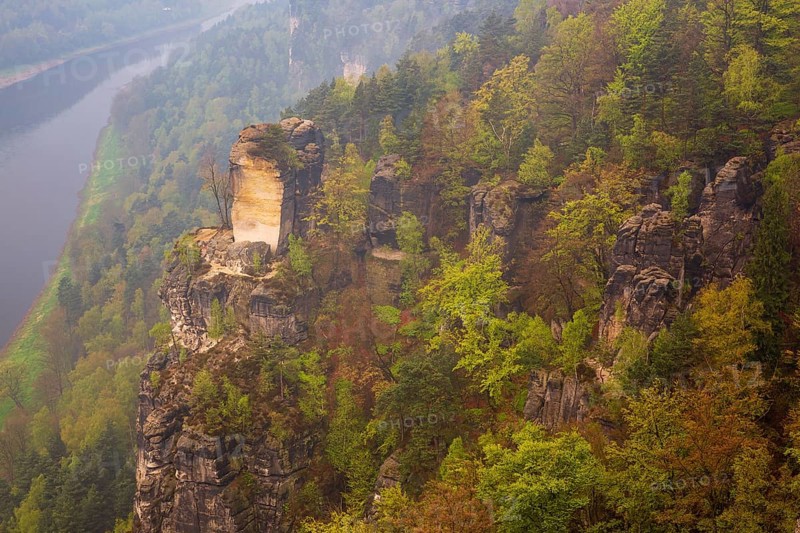 The bright lit Wartturm above the Elbe river seen from the Bastei rocks near the village of Rathen in Saxon Switzerland National Park, Saxony, Germany. On November 22, 2000 the Wartturm was the scene of a spectacular rockfall