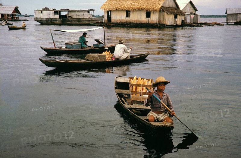 Small boats selling bread in informal huts built on logs, known as the floating city, Manaus, Brazil 1962