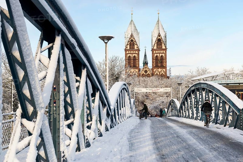 Bridge with snow and ice and cyclists, Blue Bridge and Stühlinger Church, Freiburg im Breisgau, Black Forest, Baden-Württemberg, Germany, Europe