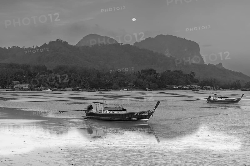Before sunrise, longtail boats lie at low tide in the harbour at Sivalai Beach, Koh Mook Island, Satun Province, Southern Thailand, Thailand, Asia
