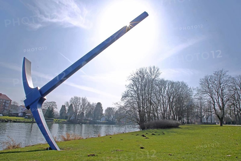 Sculpture Pickaxe by Claes Oldenburg 1982, documenta 7, backlight, XXL, oversize, very, large, pick, pickaxe, tool, garden tool, Fulda, river, bank, bridge, Karlsaue, Kassel, Hesse, Germany, Europe