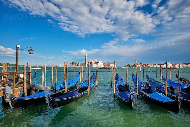 Gondolas and in lagoon of Venice by Saint Mark (San Marco) square with San Giorgio di Maggiore church in background in Venice, Italy, Europe