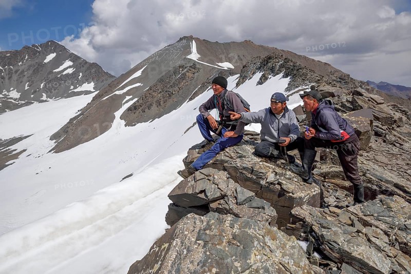 Local hikers on a ridge above the West Karakol Valley, Tian Shan Mountains, Naryn region, Kyrgyzstan, Asia