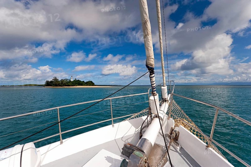 Sailing, sailing ship off uninhabited coral island Low Island near Port Douglas, Barrier reef, Quennsland, Australia, Oceania