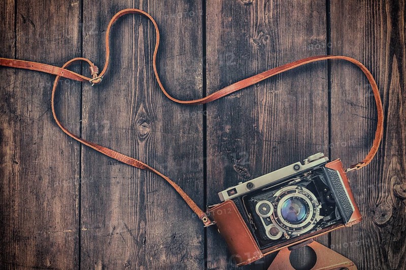 Photography concept background, old retro vintage camera on grunge wooden texture