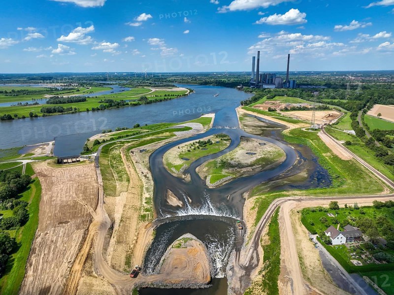 Dinslaken, Voerde, North Rhine-Westphalia, Germany, Renaturalisation of the Emscher. New Emscher estuary into the Rhine. Flood protection through land expansion. The decommissioned STEAG coal-fired power station in Voerde in the background. The mouth of the Emscher into the Rhine was moved from Dinslaken to Voerde, almost 500 metres to the north. Fish can now swim barrier-free up the new Emscher from the Rhine through a newly created floodplain area. Following the construction of a parallel sewer, the Emscher has been completely free of sewage since January 2022. The river was previously an open, above-ground combined sewer with rainwater and wastewater, Europe