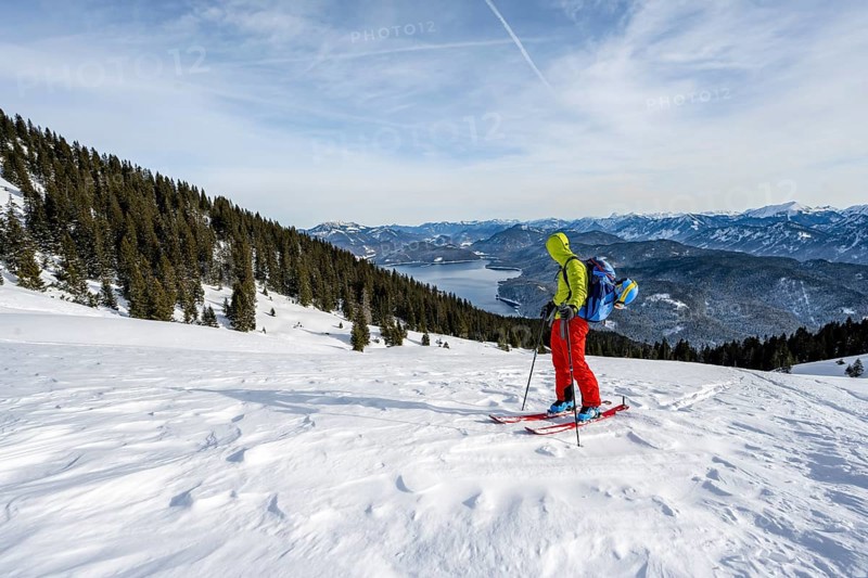 Ski tourers climbing Simetsberg, view of Walchensee, Estergebirge, Bavarian Prealps, Bavaria Germany