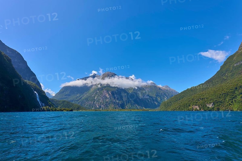 Majestic mountain landscape with clear fjord and light clouds under a sunny sky, summer, Milford Sound, Te Anau, Fiordland National Park, South Island, New Zealand, Oceania