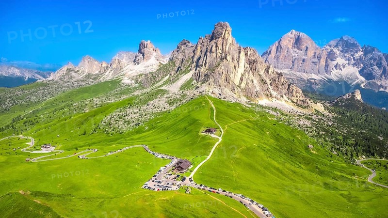 Breathtaking aerial view of the scenic passo giau with its winding road and the majestic nuvolau group in the italian dolomites during a sunny summer day