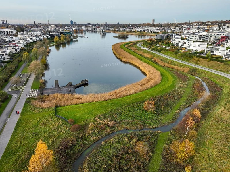 Dortmund, North Rhine-Westphalia, Germany, Phoenix Lake, front of the renaturalised Emscher. The river has been transformed into a near-natural body of water, flood protection and biodiversity through newly designed floodplains. A former industrial wasteland of 99 hectares was transformed into residential, work and leisure areas and 24 hectares of lake surface. In the event of heavy rainfall, the lake acts as a rainwater retention basin. Following the construction of a parallel sewer, the Emscher is now free of wastewater, having previously been an open, above-ground wastewater sewer, combined sewer with surface water and wastewater. The Phoenix Lake, a showcase project for structural change, is an artificial lake on the site of the former Phönix Ost steelworks in Dortmund's Hörde district, Europe