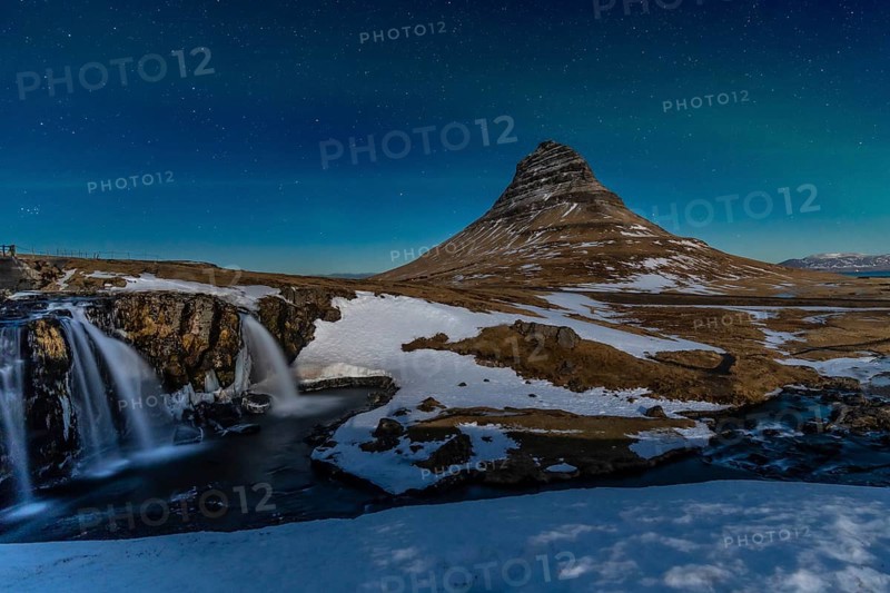 Long exposure on the picturesque Kirkjufell mountain at night in winter in Iceland