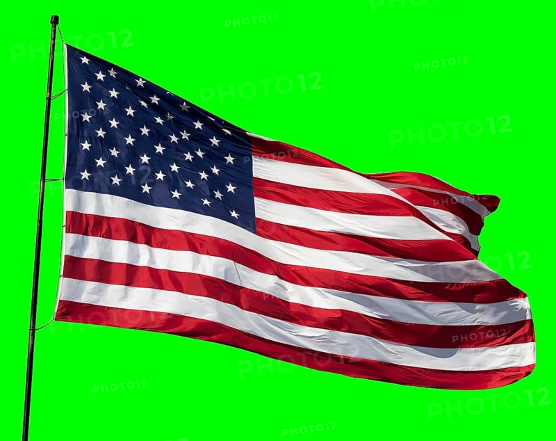 American flag waving in the wind on a flag pole over a green screen