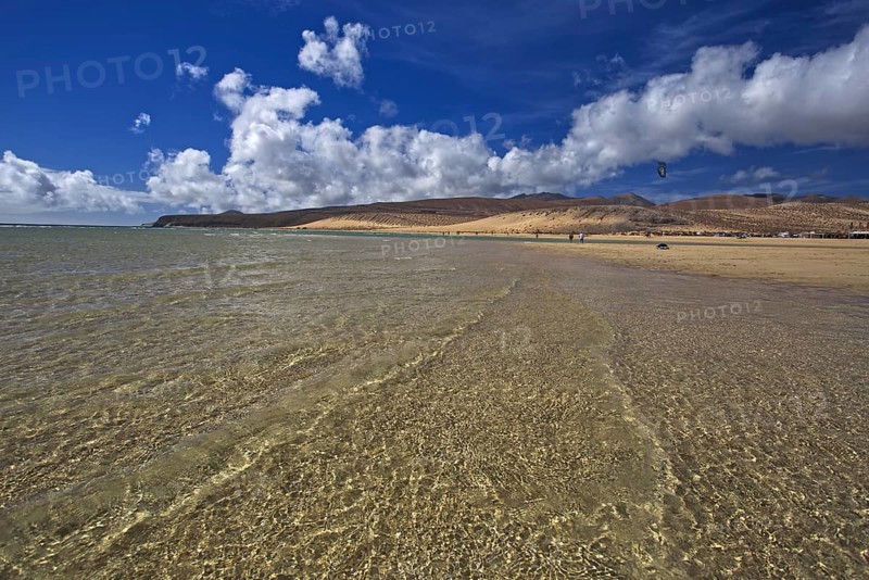 Beach Playa Risco del Paso, Playa de Sotavento with clear water, blue sky and white clouds, mountains in the background, Pajara, Fuerteventura, Canary Islands, Spain, Europe