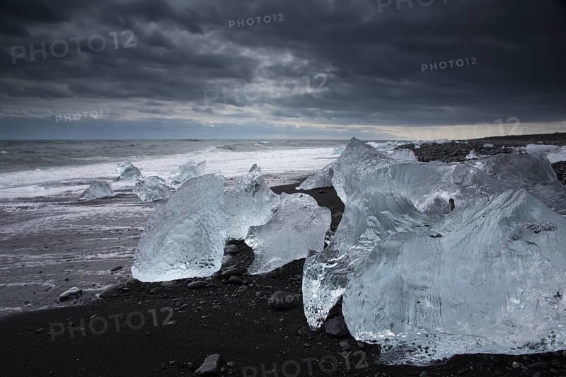 Little icebergs and crushed ice on the black beach at Joekulsarlon glacial lake