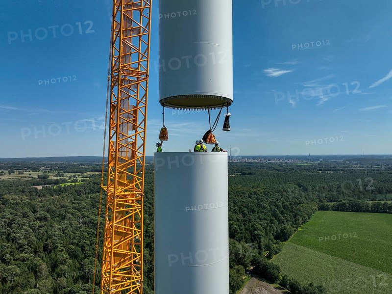 Dorsten, North Rhine-Westphalia, Germany, construction of a wind turbine, the first wind turbine of the Grosse Heide wind farm. A large mobile crane places the tower elements, the rings, on top of each other. This wind turbine will have a rated output of 5, 500 kW, Europe