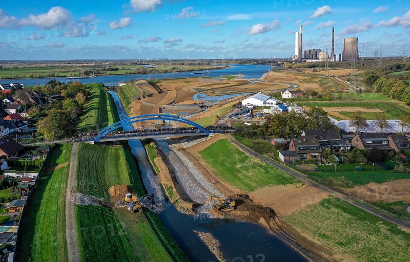 Dinslaken, Voerde, North Rhine-Westphalia, Germany, Inauguration of the new Emscher estuary into the Rhine. The decommissioned STEAG Voerde coal-fired power station is in the background. The mouth of the Emscher into the Rhine has been moved almost 500 metres north from Dinslaken to Voerde. Fish can now swim barrier-free up the new Emscher from the Rhine through a newly created floodplain area. Following the construction of a parallel sewer, the Emscher has been completely free of sewage since January 2022. The river was previously an open, above-ground combined sewer with rainwater and wastewater, Europe