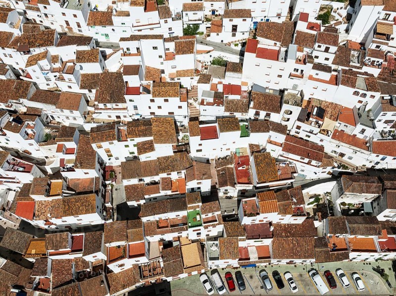 The brilliant White Town of Casares clings to a steep hillside. Aerial view. Drone shot. Málaga province, Andalusia, Spain, Europe