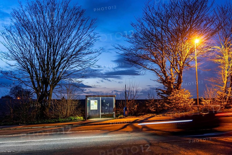 Bus stop Pierburg, in the evening, illuminated, Meisenburger Straße, Essen-Schuir, line 142, in the south of Essen, country road, Essen, North Rhine-Westphalia, Germany, Europe