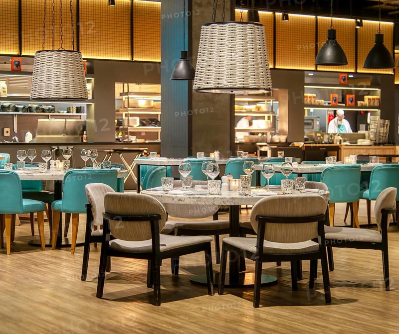 Tables and chairs set for diners in Gino D'acampo restaurant, Melia INNSiDE Liverpool hotel, Liverpool, England, UK