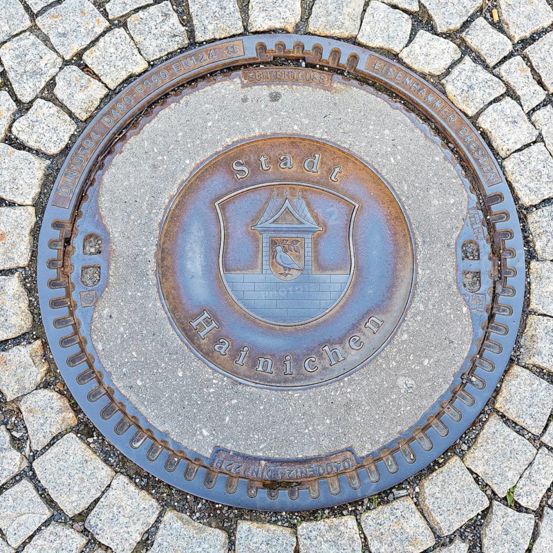 Manhole cover with coat of arms of Hainichen, Saxony, Germany, Europe
