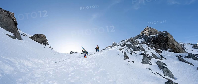 Mountaineer with skis descending through a steep snowfield on the Porta d'Es-cha, in winter, alpine tour, ski tour Bündner Haute Route, Albula Alps, Rhaetian Alps, Grisons, Eastern Switzerland, Switzerland, Europe