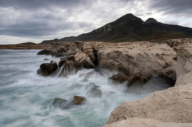 Waves on rocky coast, Playa Los Escullos, Cabo de Gata, Los Escullos, Playa del Arco, El Arco beach, Cabo de Gata-Nijar Natural Park, Almeria, Andalusia, Spain, Europe