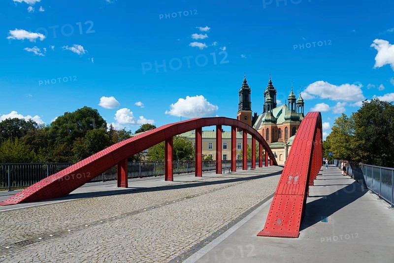A modern red bridge leads to the cathedral in the background with blue sky and white clouds, Cathedral, Cathedral Basilica of St Peter and Paul the Apostles, Bishop Jordan Bridge, Poznan, Posnan, Poznan, Greater Poland Voivodeship, Poland, Europe