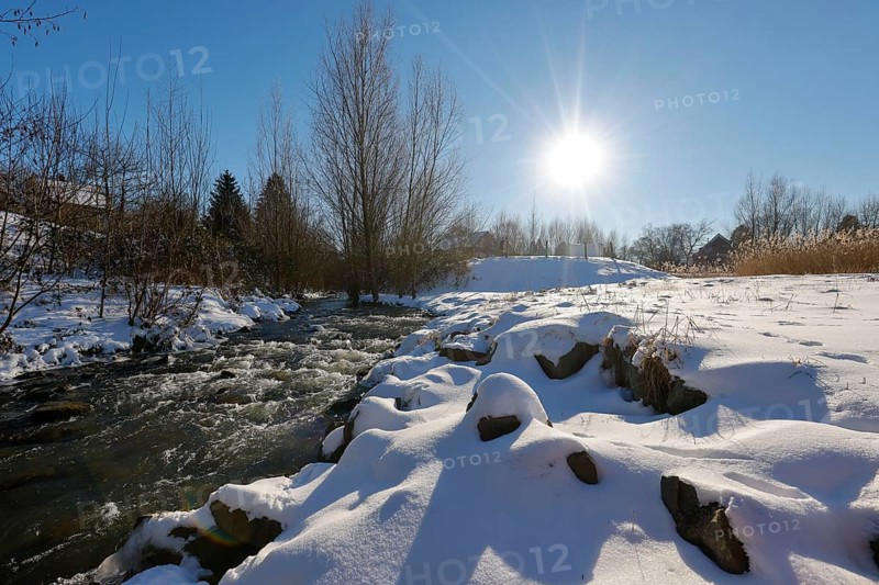 Dortmund, North Rhine-Westphalia, Germany - Sunny winter landscape in the Ruhr area, ice and snow on the renaturalised Emscher, the ecological conversion of the Emscher system consists of the construction of a central wastewater treatment system in the Ruhr area, the construction of underground sewers and the renaturalisation of the Emscher and its tributaries