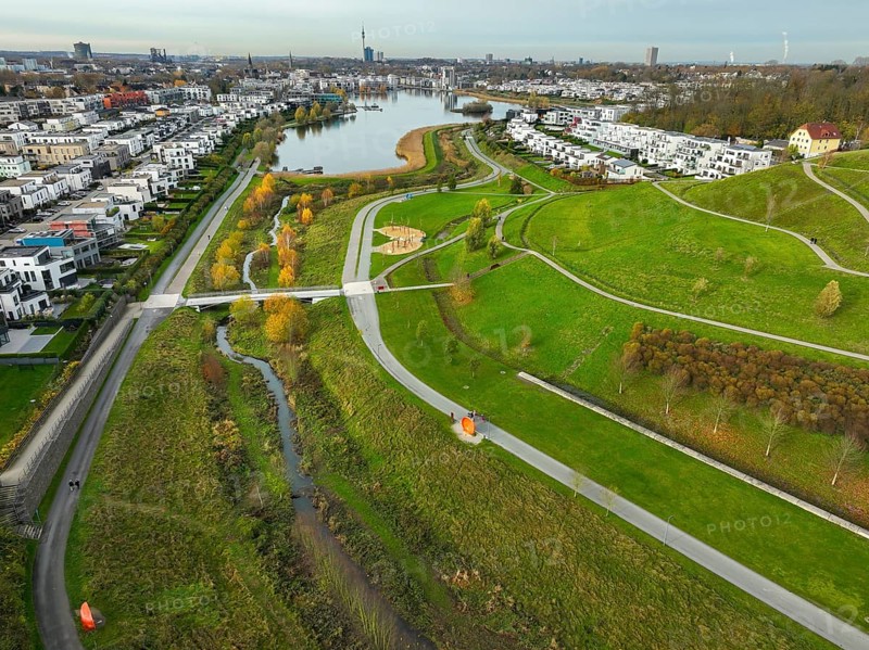 Dortmund, North Rhine-Westphalia, Germany, Phoenix Lake, front of the renaturalised Emscher. The river has been transformed into a near-natural body of water, flood protection and biodiversity through newly designed floodplains. A former industrial wasteland of 99 hectares was transformed into residential, work and leisure areas and 24 hectares of lake surface. In the event of heavy rainfall, the lake acts as a rainwater retention basin. Following the construction of a parallel sewer, the Emscher is now free of wastewater, having previously been an open, above-ground wastewater sewer, combined sewer with surface water and wastewater. The Phoenix Lake, a showcase project for structural change, is an artificial lake on the site of the former Phönix Ost steelworks in Dortmund's Hörde district, Europe