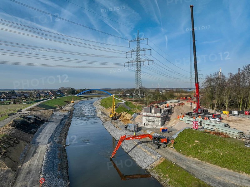Dinslaken, Voerde, North Rhine-Westphalia, Germany - New Emscher estuary into the Rhine. New construction of the railway bridge and restoration of the dykes after dyke erosion during the 2023 flood. Renaturalisation of the Emscher. Flood protection through land expansion. The mouth of the Emscher into the Rhine was moved almost 500 metres north from Dinslaken to Voerde. Fish can now swim up the new Emscher from the Rhine through a newly created floodplain area without any barriers. Following the construction of a parallel sewer, the Emscher has been completely free of sewage since January 2022. The river was previously an open, above-ground combined sewer with rainwater and wastewater