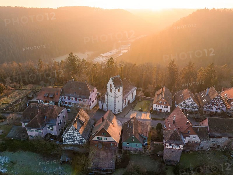 Small village with church and half-timbered houses in a hilly landscape at sunrise, Zavelstein, district of Calw, Black Forest, Germany, Europe
