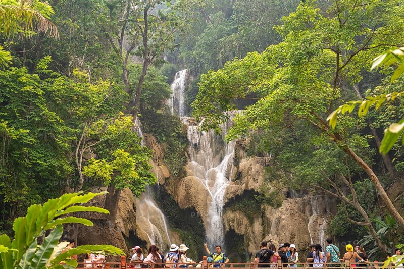 Tourists on the bridge at Kuang Si waterfall near Luang Prabang, Laos, Asia