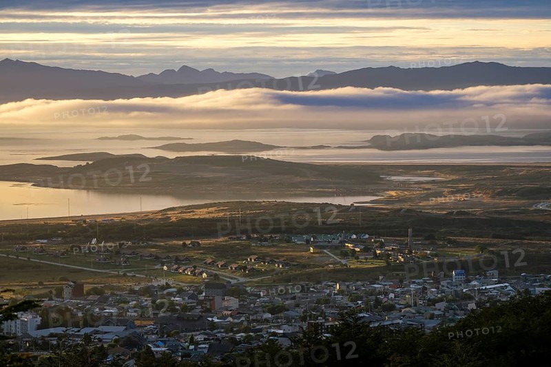 Ushuaia, Tierra del Fuego, Argentina, sunrise over the Beagle Channel, the Beagle Channel is a natural waterway at the southern tip of South America that connects the Atlantic Ocean with the Pacific Ocean. Ushuaia is the southernmost city in the world, the end of the world. Behind mountain range on the island of Navarino in Chile, Dientes de Navarino, South America