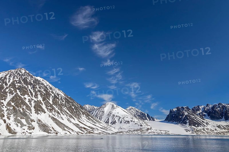 Cirrus uncinus clouds above mountain with glacier along Magdalenefjorden, fjord in Albert I Land on Svalbard, Spitsbergen, Norway, Europe