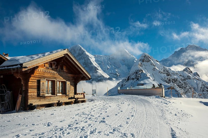 Wooden chalet and ski slope, with views of the Eiger, Mönch and Tschuggen, Grindelwald, Bernese Alps, Canton of Bern, Switzerland, Europe