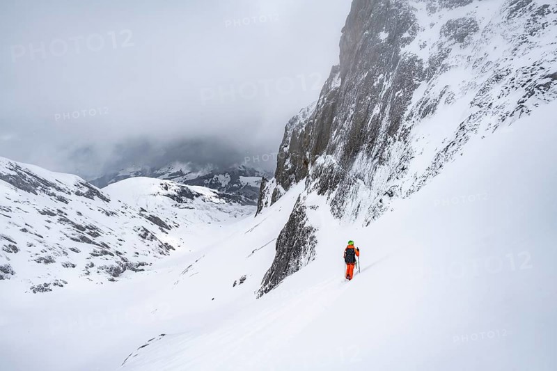 Ski tourer on a steep mountain slope, Snowy mountain landscape, Bernese Alps, Bernese Oberland, Switzerland, Europe