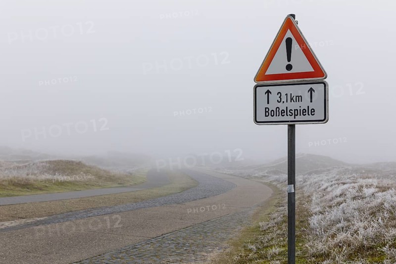 Road in the fog with traffic sign, attention, dune landscape on Norderney, Lower Saxony, Germany, Europe