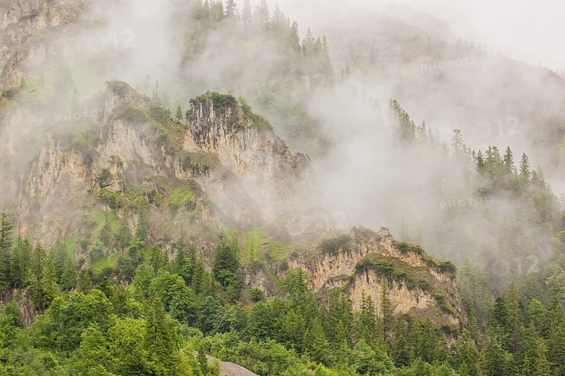 Wisps of mist cover the Karwendel mountains in the Großer Ahornboden nature reserve, Eng Valley, Tyrol, Austria, Europe