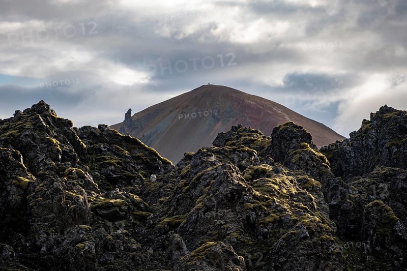 Lava field in front of colourful rhyolite mountain Brennisteinsalda, volcanic landscape, erosion landscape, Landmannalaugar, Fjallabak Nature Reserve, Icelandic Highlands, Suðurland, Iceland, Europe