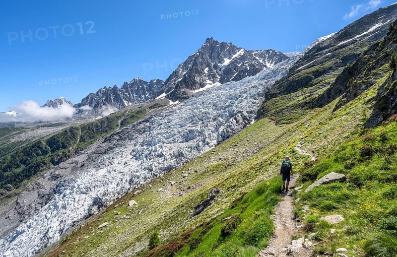Hiking on the trail to La Jonction, Glacier des Bossons, behind the summit of the Aiguille du Midi, Chamonix, Haute-Savoie, France, Europe