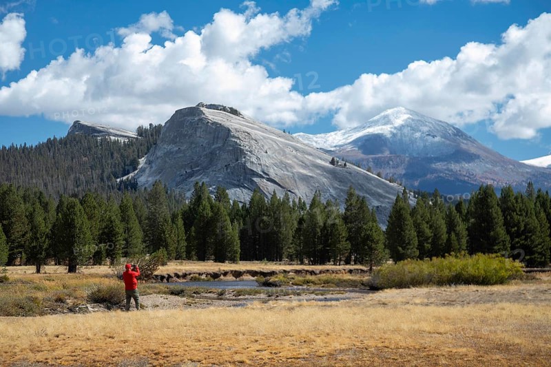Yosemite National Park, California - A man takes pictures of Lembert Dome above Tuolumne Meadows in Yosemite National Park