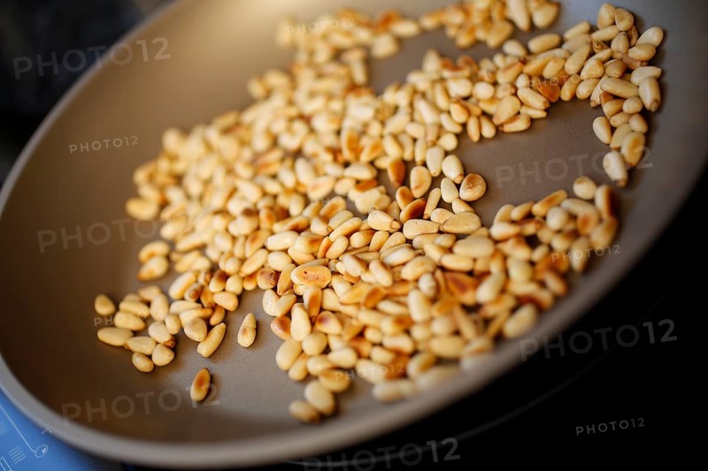 Swabian cuisine, preparation of beef roulade with pine nuts, roasting pine nuts in a pan, grandmother's cooking, regional, home cooking, typical Swabian, traditional cuisine reinterpreted, food photography, studio, Germany, Europe
