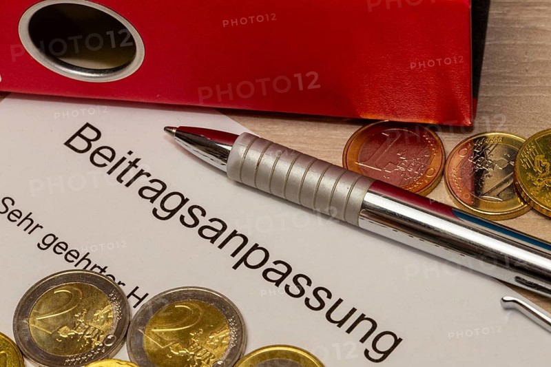 Symbolic image of contribution increase: cover letter, euro coins, biros and folder