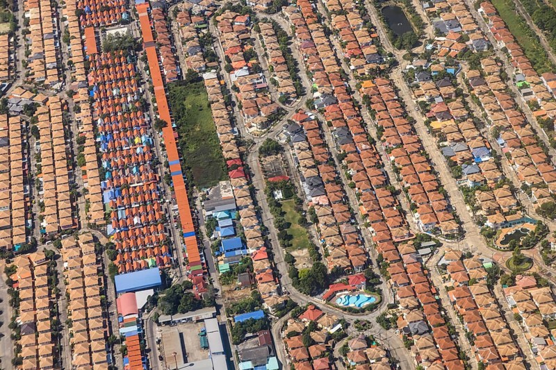 Retort city in the north-east of Bangkok. Standardised houses stand close together on the straight streets of a housing estate. Urban planning from the retort. Approaching Don Mueang Airport, Bangkok, Thailand, Asia