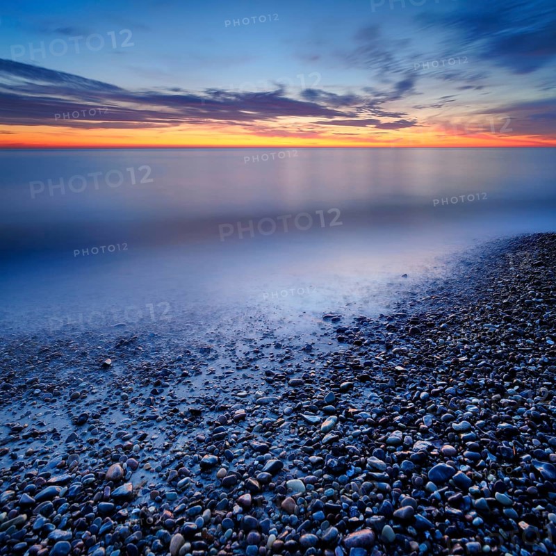 Pebbles in the water on the shore of the Baltic Sea at dusk after sunset, Weststrand Darß, peninsula Fischland-Darß-Zingst, National Park Vorpommersche Boddenlandschaft, Mecklenburg-Vorpommern, Germany, Europe