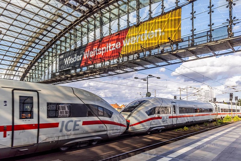 Becoming world class again. ICE, Berlin, central station with platform hall with glass roof construction, banner with German flag and the slogan