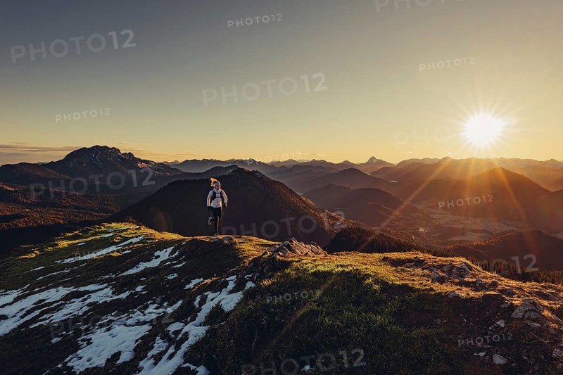 Trail running in autumn on the Jochberg on Lake Walchensee against the wonderful backdrop of the Alps, Bavaria, Germany, Europe