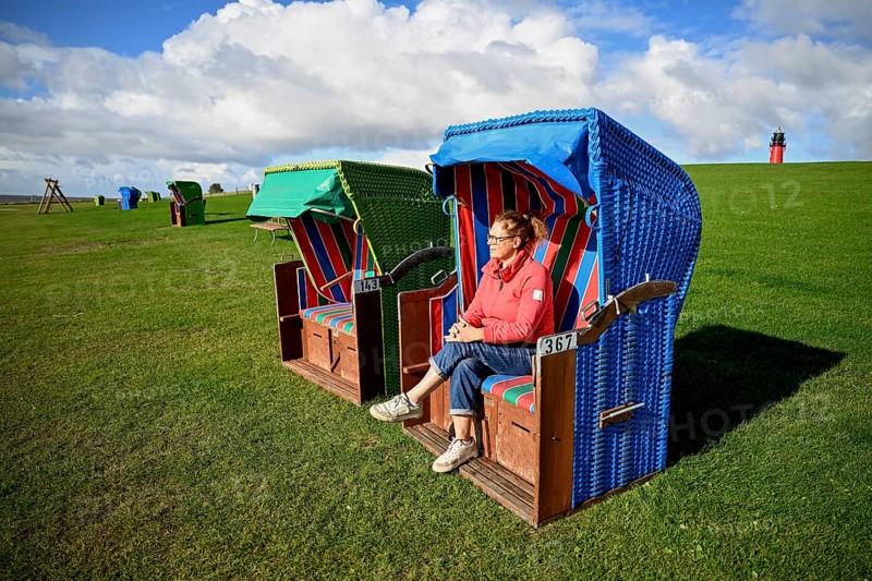 Woman in a beach chair on the island of Pellworm, Wadden Sea National Park, North Frisia, Germany, Europe